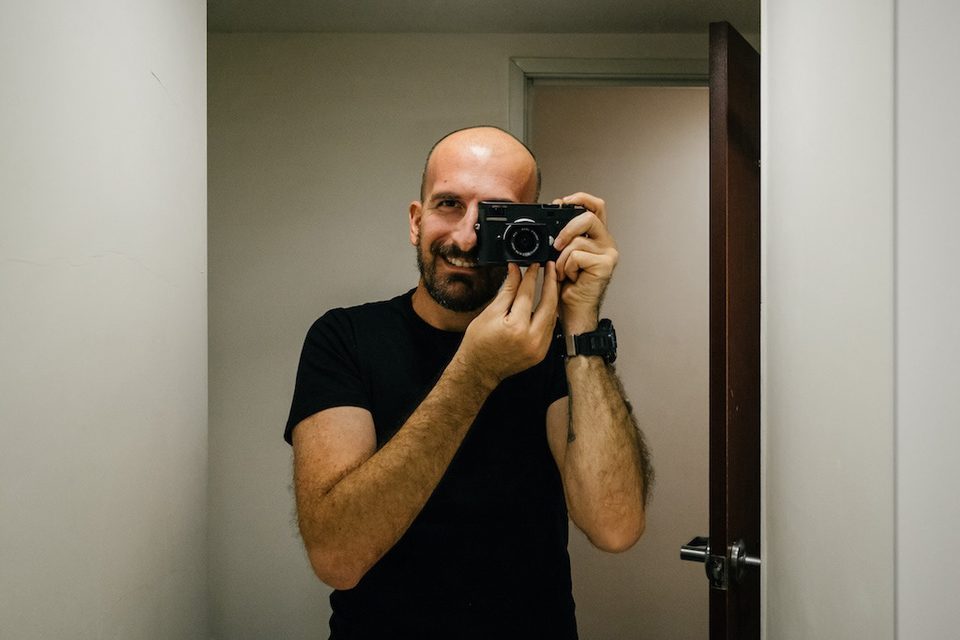 Dennis Berti, documentary photographer, at work